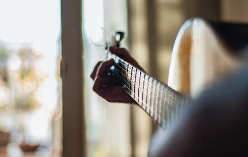 guitar person playing guitar indoors electric guitar